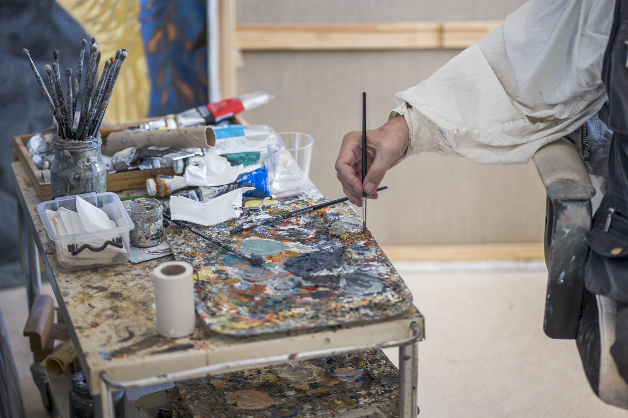 This picture shows artist Lennart Olausson painting in his studio